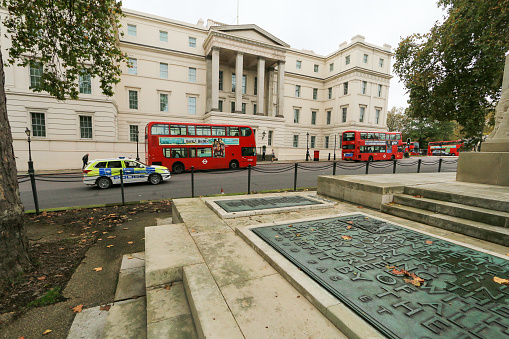 Royal Artillery Memorial in Hyde Park Corner, London. This memorial dedicated to the nearly 50,000 soldiers from the Royal Artillery killed in World War 1, was designed by Charles Sargeant Jagger and  was revealed in 1925. A police car and buses can be seen in the background