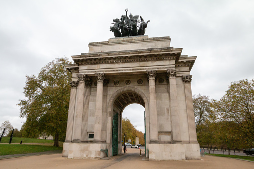 This Grade I-listed triumphal arch was designed by Decimus Burton. It stands between Green Park and Hyde Park on Hyde Park Corner. It was built between 1816-1830, although it has been moved from its original location. It was built to commemorate Britain;s victory against Napoleon in the Napoleonic Wars. People can be seen in the background.
