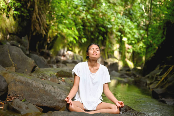 istock Woman meditating in the woods 1285738981