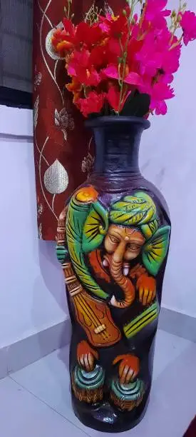 Photo of Lord ganesh embedded artificial flower pot