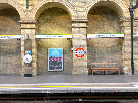 Notting Hill Gate Underground Station in Bayswater, London, with a poster for the boyband Westlife in the background