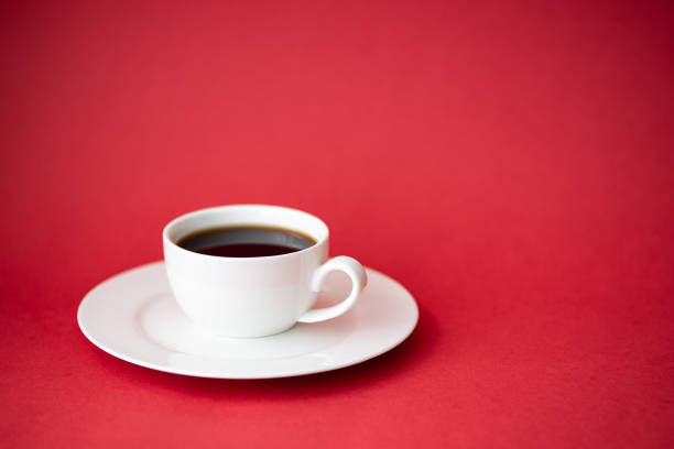 istock black coffee in a small coffee cup on a red background 1285741726