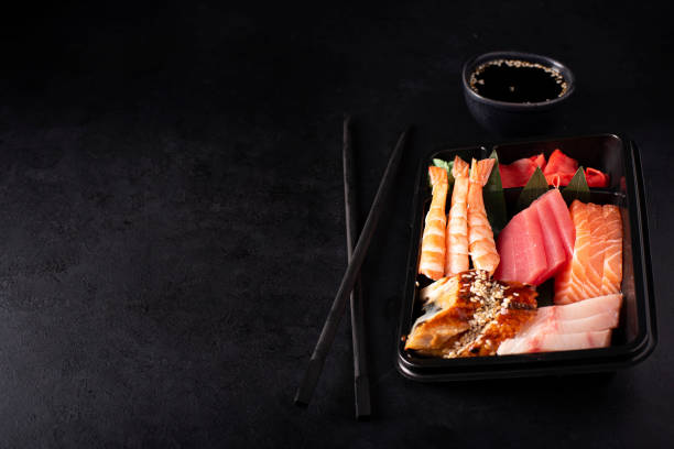 istock sashimi set of salmon, shrimp, tuna and eel in a black plastic container 1285742594