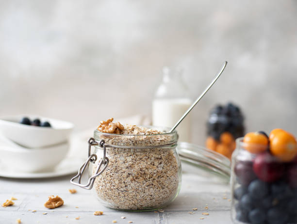 oatmeal with berries, milk and nuts oatmeal with berries, milk and nuts on a white background yogurt fruit biscotti berry fruit stock pictures, royalty-free photos & images