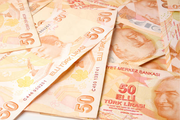 istock Stack of one hundred pieces fifty turkish lira bills isolated on white 1285743032