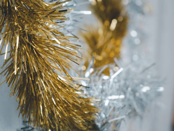 istock Golden and silver  tinsel, Christmas ornament over white background 1285744435
