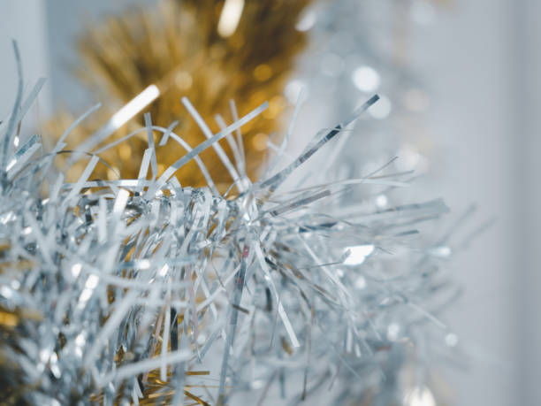 istock Golden and silver  tinsel, Christmas ornament over white background 1285744437