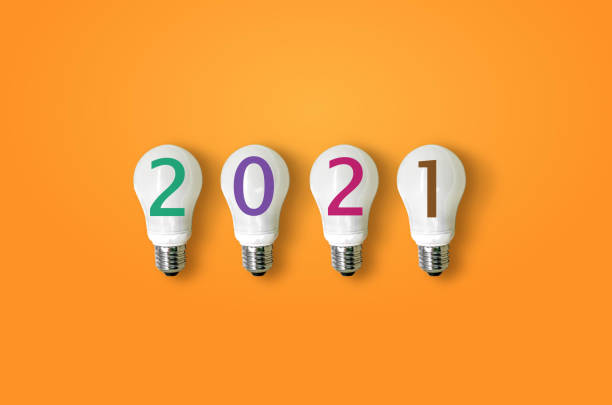 istock year 2021 on light bulbs. creativity inspiration , planning ideas concept 1285745341