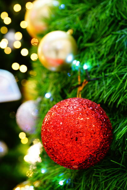 istock Red color ball ornament hanging on a pine tree 1285745808