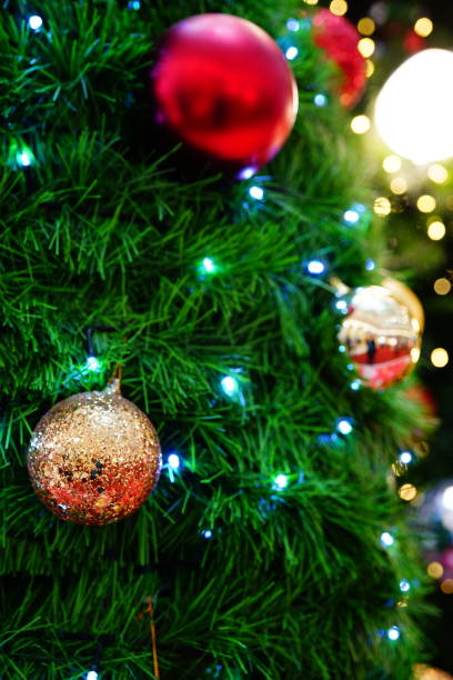 istock Red color ball ornament hanging on a pine tree 1285745826