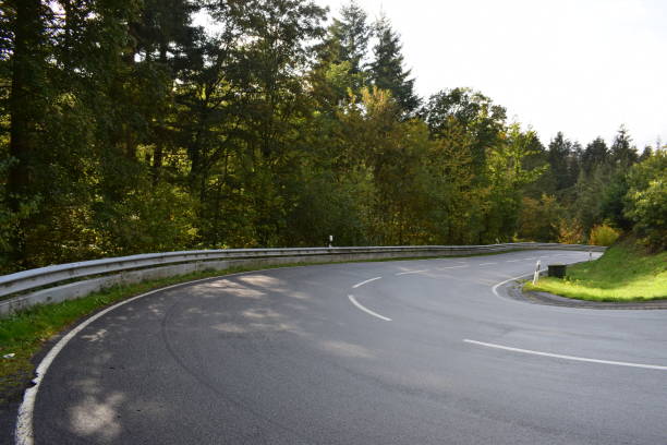 istock serpentine road through autumn forest 1285747903