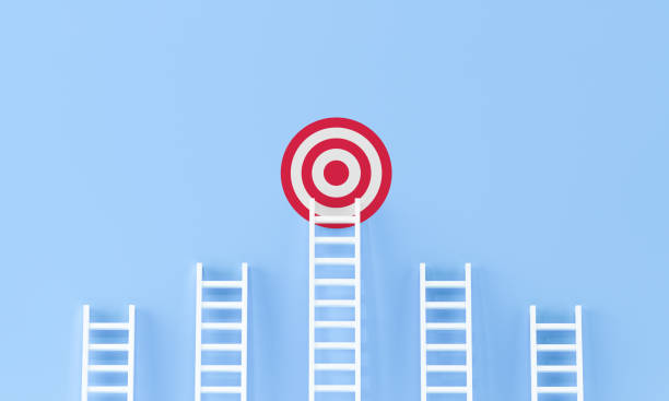 istock Target ladder achievement concept on blue wall studio background. 1285748990