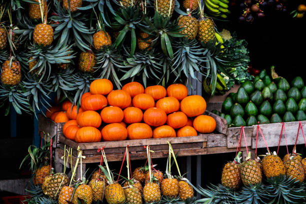 Yellow melon. Many melons to be sold and pineapple in the background
