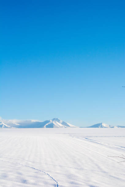 istock Snowfields and snowy mountains with a blue sky 1285750004