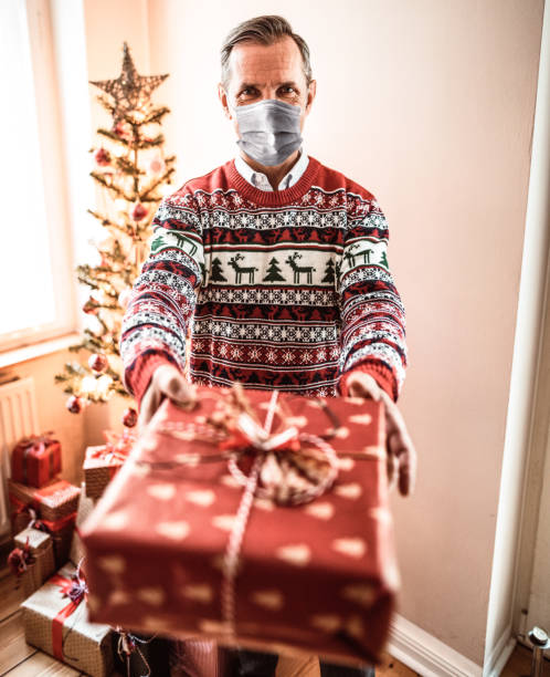 istock solo man at home in front of christmas tree 1285751163
