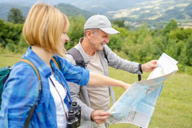 istock Father and daughter looking for directions on the map and smiling 1285752325
