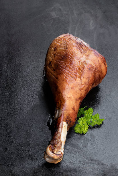 istock Roasted turkey leg on black stone background 1285753820