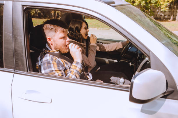 istock couple having chocolate snack while riding in car 1285759696