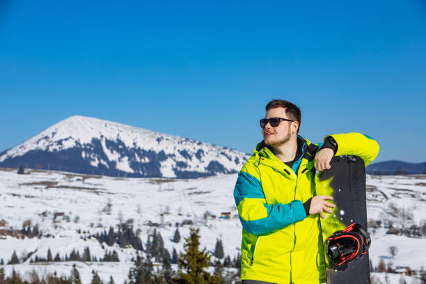 istock man in sunglasses holding snowboard 1285760485