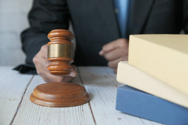 istock close up of person's hand striking the gavel. 1285764149