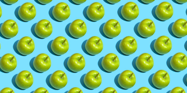 istock Fruit pattern of fresh green apples on blue background. Top view. Summer concept. Collage 1285765516