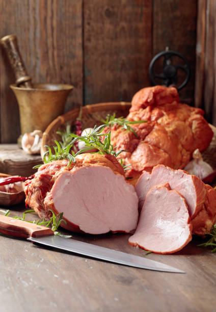istock Smoked ham on an old wooden table. 1285765530