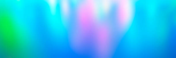 istock Blurred colorful multicolored background from lights. Iridescent holographic abstract bright neon colors backdrop. banner 1285765647