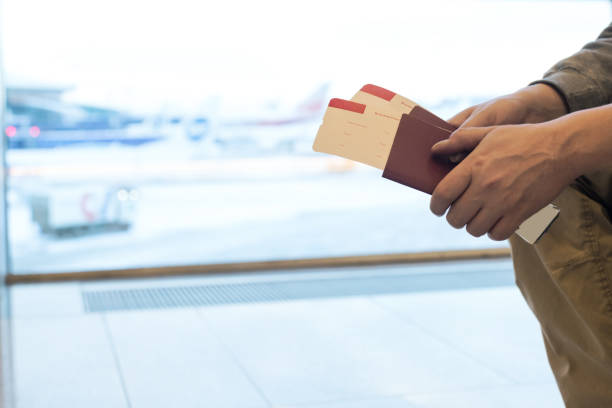 istock Man with boarding passport in hands 1285767474