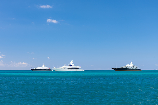 Mega Yachts anchored against the horizon in the Caribbean, St. Maarten