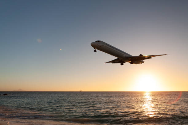 istock Jet airplane at sunset on tropical beach 1285767981