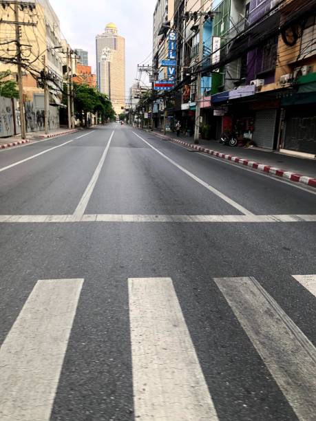 The long long road as far as the eye can reach to the State Tower Charoen Krung Road, the first road was build in Thailand, during the lock down of Covid outbreak lead to the State Tower as far as the eye can reach. bangkok street stock pictures, royalty-free photos & images