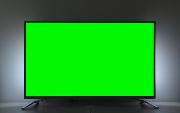 Close up of big green screen led TV in a cozy living room. Close up of big green screen led TV in a cozy living room. chroma key stock pictures, royalty-free photos & images