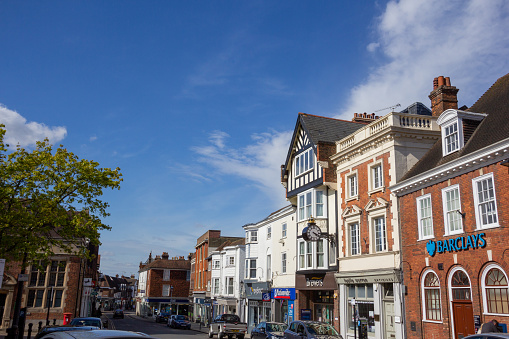 Sevenoaks High Street in Kent, England. Several stores are visible such as Barclays Bank on the right. There are also people in the background.