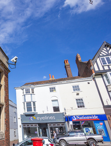 This British mutual financial institution was founded in 1846. It is next to Eyelines Opticians in Sevenoaks High Street. People are visible.