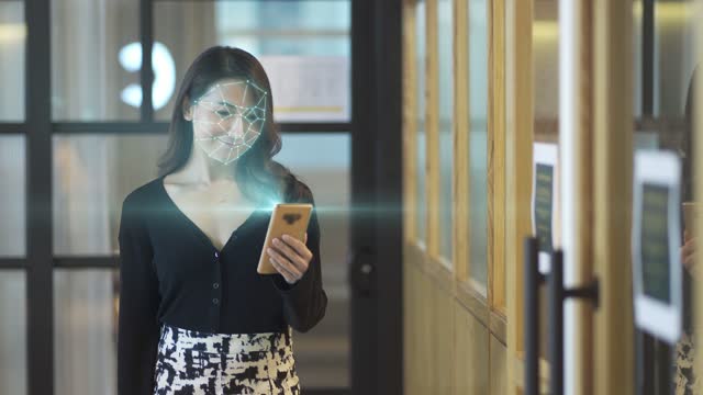 asian chinese turn on smart phone for face recognition system and access to internet