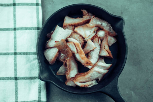 istock Charcoal-boiled pork neck served on black pan. A popular appetizer in Thailand. 1285773513