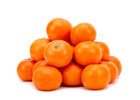 Heap of ripe tangerines on a white background.