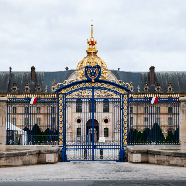 Grand view of Les Invalides and its golden dome, a significant landmark in Paris, with expansive gardens under a clear sky.