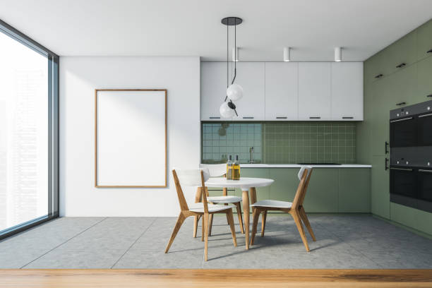 istock Modern white and green kitchen with dining table and poster 1285775380
