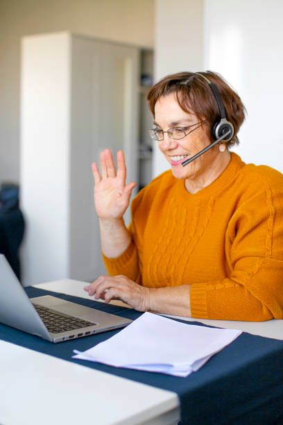 istock Senior woman having online conversation. Vertical photo 1285780258
