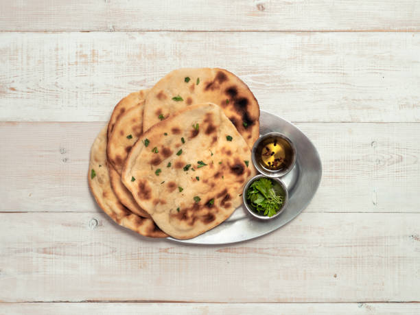 istock naan flatbreads on white wood, copy space, top view 1285780614