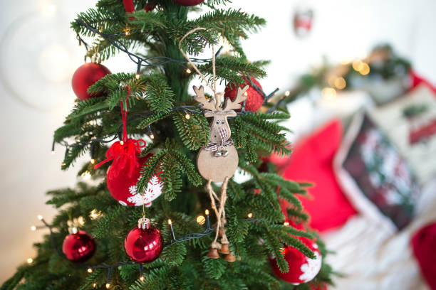 istock Red Christmas decoration on the Christmas tree with lights garlands. 1285780723