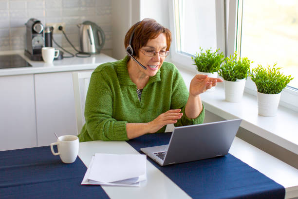 istock An elderly woman makes an online call using a laptop 1285780845