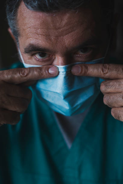 istock Doctor showing how to put a protective mask on face during pandemic 1285781507