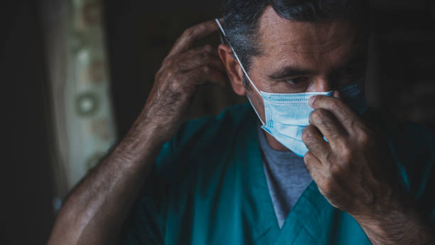 istock Doctor showing how to put a protective mask on face during pandemic 1285781580