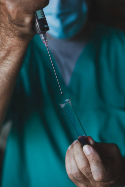 istock Doctor analyzing blood during coronavirus pandemic 1285782536