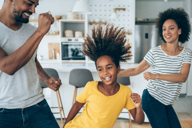Family dancing in living room.