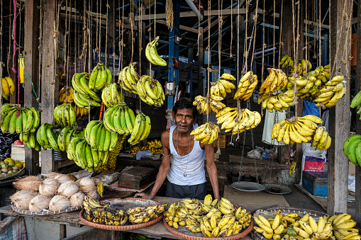 Tezpur, India - November 2020: Banana seller in the Tezpur market on November 14, 2020 in Assam, India.