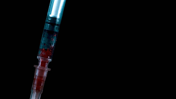 istock Taking blood with a syringe. Addict's infected blood 1285784935