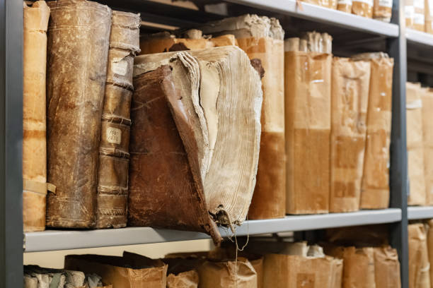 istock Old worn 17th century books on a shelf in the library's shelfs 1285787553